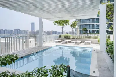 a swimming pool on the roof of a building at Stayis I Beachfront Luxury 1BR with Private Access in Dubai