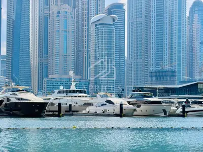 a group of boats docked in a harbor in a city at Sea and Palm View from 1BD apt in Beachfront in Dubai