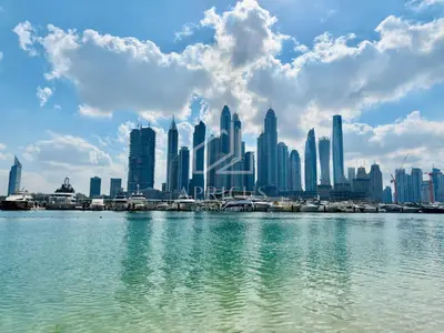 a view of a city skyline from the water at Sea and Palm View from 1BD apt in Beachfront in Dubai