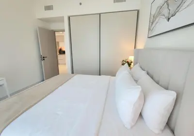 a bedroom with a white bed with white pillows at Sea and Palm View from 1BD apt in Beachfront in Dubai