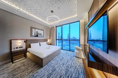a hotel room with a bed and a large window at Downtown Views I - Burj Khalifa View, Downtown Dubai in Dubai