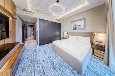 a hotel room with a bed and a television at Downtown Views I - Burj Khalifa View, Downtown Dubai in Dubai