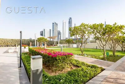 a park with flowers and a city in the background at Downtown Views I - Burj Khalifa View, Downtown Dubai in Dubai