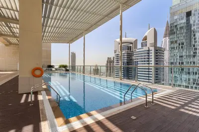 a swimming pool on the roof of a building at Silkhaus Modern Studio in The Heart of DIFC in Dubai