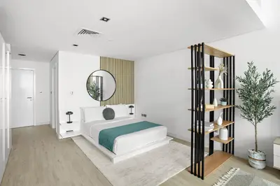 a white bedroom with a bed and a mirror at Silkhaus Modern Studio in The Heart of DIFC in Dubai