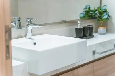 a bathroom with a white sink and a mirror at Wonderful Studio with Balcony & City Views in Dubai