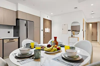 a kitchen with a table with bananas and fruit on it at Burj Khalifa Views Stylish 2BR Near Dubai Mall and Metro in Dubai