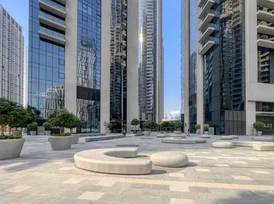 a courtyard in a city with tall buildings at Burj Khalifa Views Stylish 2BR Near Dubai Mall and Metro in Dubai