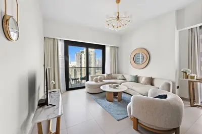 a living room with a couch and a table at Burj Khalifa Views Stylish 2BR Near Dubai Mall and Metro in Dubai