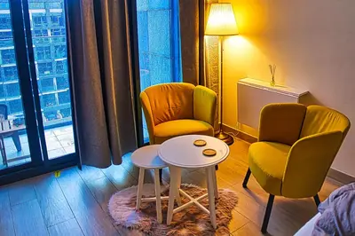 a living room with two chairs and a table in a room at Stylish Studio Retreat in Dubai