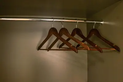 a bunch of wooden hangers in a closet at Stylish Studio Retreat in Dubai