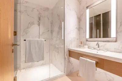 a bathroom with a shower and a sink at Address Opera Residences Burj Khalifa View in Dubai