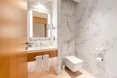 a bathroom with a toilet and a sink at Address Opera Residences Burj Khalifa View in Dubai