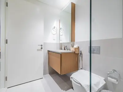 a bathroom with a sink and a toilet at Pearl of Creek Beach: 1BR Luxury Beach Apartment in Dubai