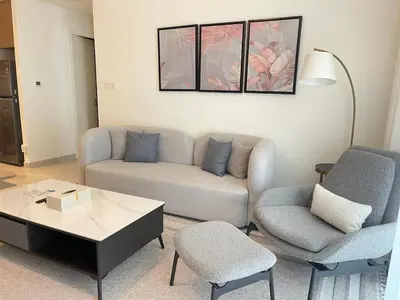 a living room with a couch and two chairs at Pearl of Creek Beach: 1BR Luxury Beach Apartment in Dubai