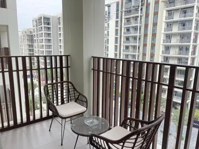 a balcony with two chairs and a glass table at Pearl of Creek Beach: 1BR Luxury Beach Apartment in Dubai