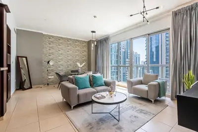 a living room with two couches and a table at Cozy 1 Bedroom apartment I Downtown Dubai I Near Burj Khalifa in Dubai