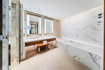 a bathroom with a tub and a sink and a mirror at Address Residences Dubai Opera - Burj Khalifa & Fountain View, Downtown Dubai in Dubai