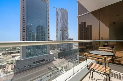 a balcony with a view of a city with tall buildings at Newly Furnished Studio in JLT in Dubai