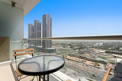 a table in a room with a view of a city at Newly Furnished Studio in JLT in Dubai