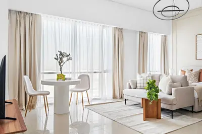 a living room with a couch and a table at Silkhaus Elegant Studio Near Silicon Central Mall in Dubai