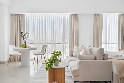 a living room with a couch and a table at Silkhaus Elegant Studio Near Silicon Central Mall in Dubai