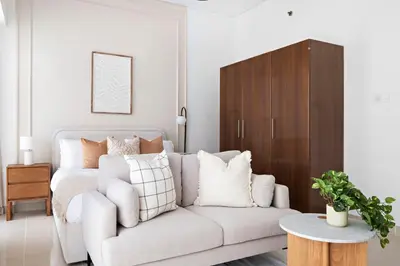 a living room with a couch and a bed at Silkhaus Elegant Studio Near Silicon Central Mall in Dubai