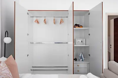 a bedroom with a closet with shoes hanging on it at Silkhaus Elegant Studio Near Silicon Central Mall in Dubai