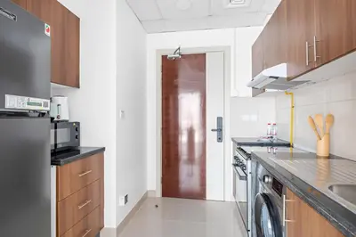 a kitchen with a sink and a dishwasher at Silkhaus Elegant Studio Near Silicon Central Mall in Dubai