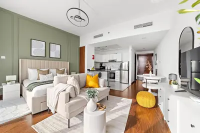 a bedroom with a bed and a living room at Silkhaus Chic Luxury Studio Opposite Silicon Oasis Shopping Mall in Dubai