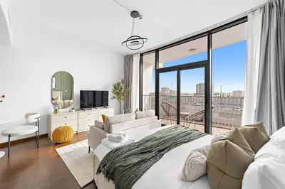 a bedroom with a large bed and a large window at Silkhaus Chic Luxury Studio Opposite Silicon Oasis Shopping Mall in Dubai