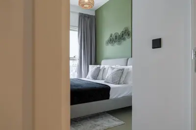 a bedroom with a bed and a window at Cozy One Bedroom Near Dubai Hills Mall in Dubai