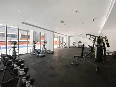 a gym with several exercise bikes and a pool at Silkhaus Chic Studio Near Silicon Oasis Shopping Mall in Dubai