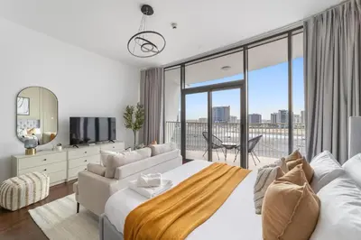 a bedroom with a large bed and a large window at Silkhaus Chic Studio Near Silicon Oasis Shopping Mall in Dubai
