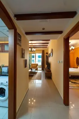 a hallway of a house with a washing machine in it at Fantastic Apartment near Metro and jbr beach in Dubai