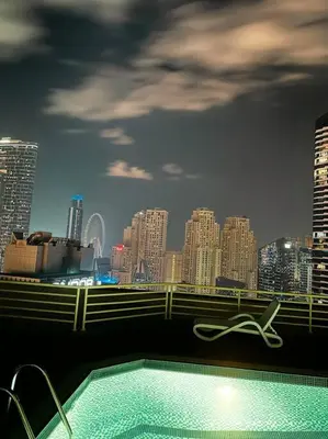 a swimming pool with a city skyline in the background at Fantastic Apartment near Metro and jbr beach in Dubai