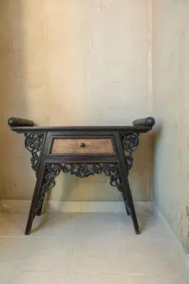 a small black table in a corner of a wall at Fantastic Apartment near Metro and jbr beach in Dubai