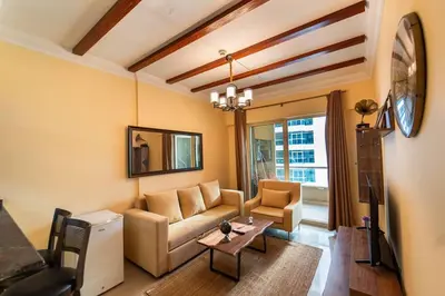 a living room with a couch and a table at Fantastic Apartment near Metro and jbr beach in Dubai