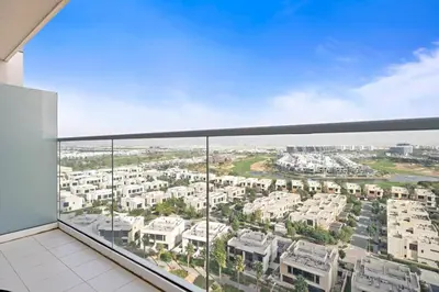 a balcony with a view of a city at Cozy Studio in Damac Hills in Dubai
