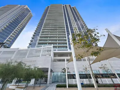 a tall building with two tall buildings at Cozy Studio in Damac Hills in Dubai