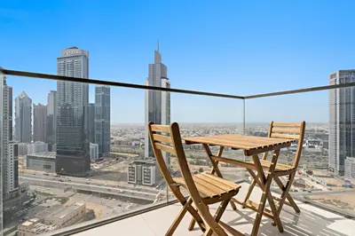 a table and chairs on the roof of a building at Luxurious 2 BR in Downtown Dubai in Dubai