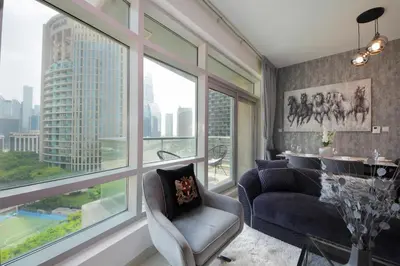 a living room with a view of a city at Spectacular 1BHK near Dubai Mall in The Lofts East - TrueBleu Homes in Dubai