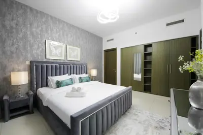 a bedroom with a large bed in a room at Spectacular 1BHK near Dubai Mall in The Lofts East - TrueBleu Homes in Dubai