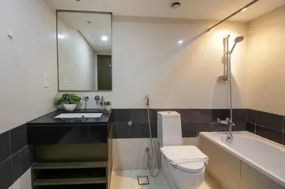 a bathroom with a toilet and a sink and a tub at Spectacular 1BHK near Dubai Mall in The Lofts East - TrueBleu Homes in Dubai