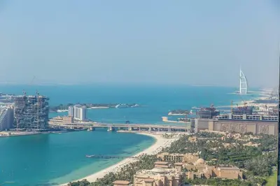 a view of a city with a beach and a bridge at Cayan Tower Dubai Marina - By Home Of Choice in Dubai