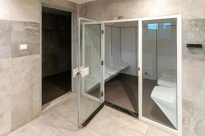 a walk in shower with glass doors in a bathroom at Modern Studio with Canal View in Business Bay in Dubai