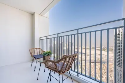 a balcony with chairs and a view of the city at Luxury 1BR Retreat l 17 Icon Bay, Dubai Creek in Dubai