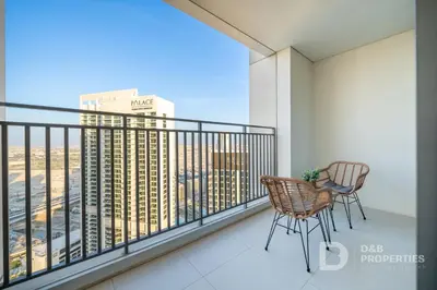 a balcony with two chairs and a view of a city at Luxury 1BR Retreat l 17 Icon Bay, Dubai Creek in Dubai