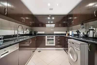 a kitchen with a sink and a dishwasher at Full Sea View 1 BR with Lagoon Pool & Beach Access in Dubai