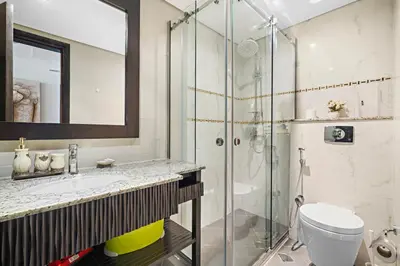 a bathroom with a shower and a sink and a toilet at Full Sea View 1 BR with Lagoon Pool & Beach Access in Dubai